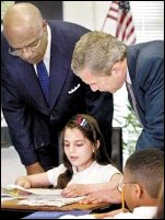 During the "No Child Left Behind" Tour Across America, Mariam Karana, a fourth-grade student at Vandenberg Elementary, shows Secretary Paige and President Bush her schoolwork.