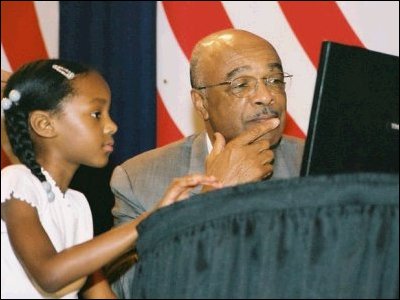 Second-grader Taylor Lemmons shows Sec. Paige a Colorado Virtual Academy lesson using the Internet.  "Computers are becoming for our children what chalk was for our parents -- an essential teaching tool," says Paige.  In 2000, 98 percent of all K-12 schools in America had computers with access to the Internet.